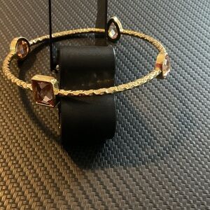 Elegant Gold Bangle with Gemstone Accents